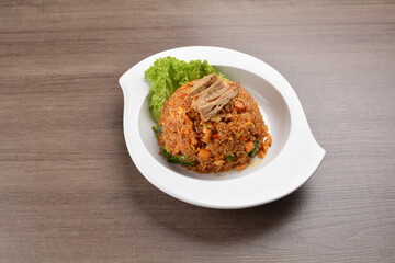 vegetarian nasi goreng fried rice with pineapple, vegetables meat in spicy chilli sambal sauce on wood background asian halal vegan menu