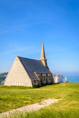 Fototapeta na wymiar Notre-Dame de la Garde chapel, the arch and the Needle in Etretat, Normandy