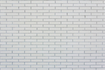 Wall of medium sized lined white bricks. Texture. Background.