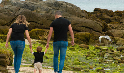 family walking in the beach