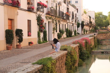 woman sitting in typical street of Cordoba Spain