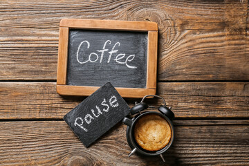 Cup of coffee and chalk boards on wooden background