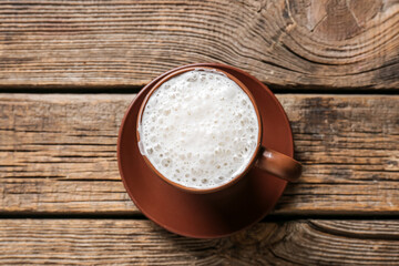 Cup of coffee on wooden background
