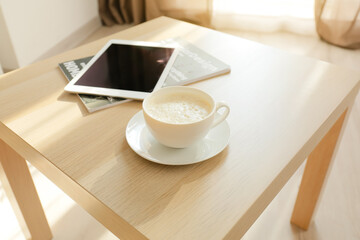 Cup of coffee on table in room