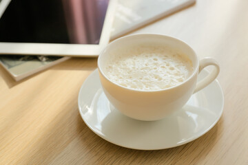 Cup of coffee on table in room, closeup