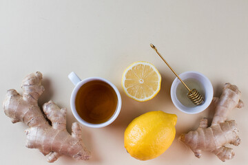 Flatlay tea, lemon and ginger. The concept of autumn warming tea. Copy space.