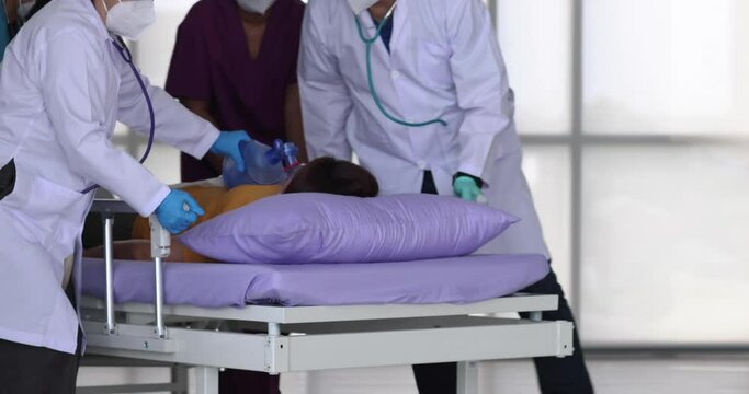 Team group of doctor and medical persons help to move a female patient on bed hurry up for treatment. Concept of good service in healthcare business.