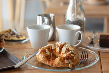 Sweet Croissant almond server with americano and latte and chocolate tart on wooden desk in cafe. - 448019884
