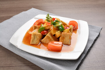deep fried bean curd tofu with spicy sweet and sour chilli sauce on wood background asian halal vegan menu
