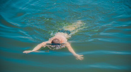 Fototapeta premium 13 years Teenage boy swimming in lake, Children lifestyle. Enjoy the life