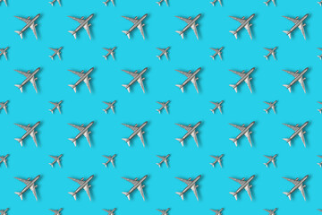 Soaring silver airplanes on a colored background. Repeating Chil