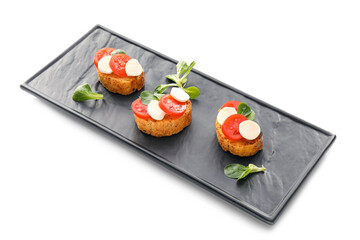Tasty bruschettas with mozzarella cheese and tomatoes on white background