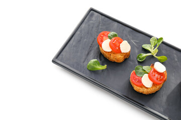Tasty bruschettas with mozzarella cheese and tomatoes on white background