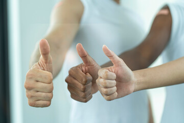 With a thumbs up from three people of different colors, three nationalities, Asians, salespeople and African Americans. 