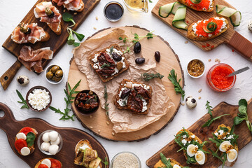 Different tasty bruschettas on light background, closeup