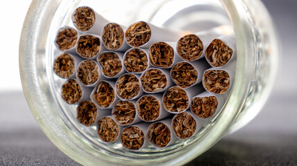close up of a cigarette inside of a jar
