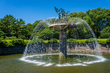 The symbolic fountain against the backdrop of the blue sky in Showa Kinen Park, Tachikawa, Tokyo.