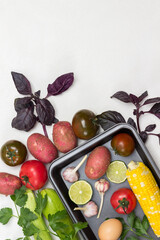 Yellow corn, tomatoes, potatoes on table. Vegetables on pallet.