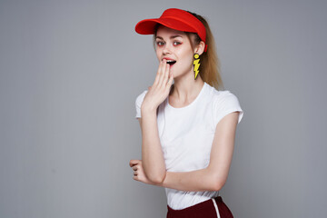 cheerful pretty girl red cap makeup earrings glamor isolated background
