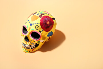 Painted human skull for Mexico's Day of the Dead (El Dia de Muertos) on color background