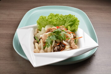 thai cold mushroom vegetable salad in spicy sour lime sauce on wood background asian halal vegan menu