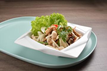 thai cold mushroom vegetable salad in spicy sour lime sauce on wood background asian halal vegan menu