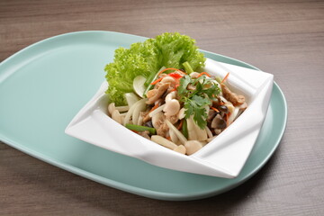 thai cold mushroom vegetable salad in spicy sour lime sauce on wood background asian halal vegan menu