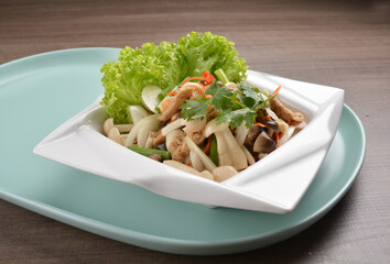 thai cold mushroom vegetable salad in spicy sour lime sauce on wood background asian halal vegan menu