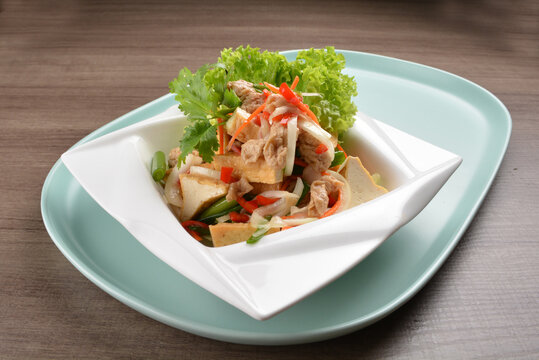 thai cold bean curd tofu vegetable salad in spicy sour lime sauce on wood background asian halal vegan menu