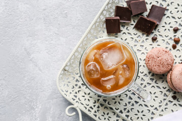 Cup of ice coffee with milk on table
