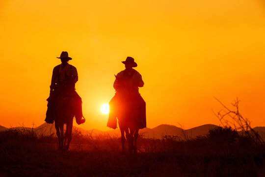 Cowboy silhouette riding a horse When the sunset looks beautiful
