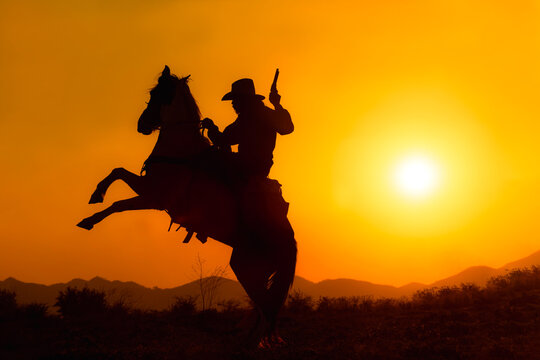 Cowboy silhouette riding a horse When the sunset looks beautiful
