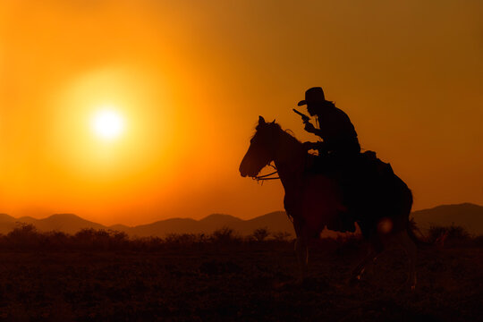 Cowboy silhouette riding a horse When the sunset looks beautiful
