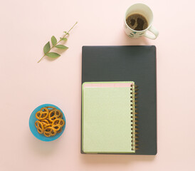 Creative minimal concept of laptop, notebook, coffee, leaf and pretzels. Flat lay