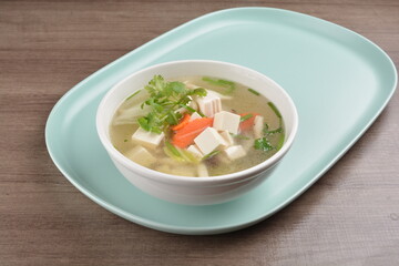 healthy white bean curd tofu and mixed vegetable hot soup on wood background asian halal vegan menu