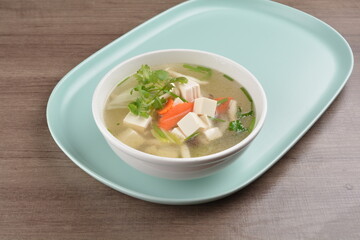 healthy white bean curd tofu and mixed vegetable hot soup on wood background asian halal vegan menu