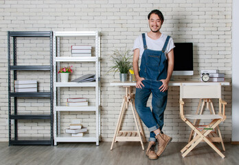 Fototapeta na wymiar Young hipster beard Asian man standing with happy in his new modern minimal startup office, concept for happy businessman with small business starting