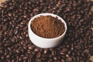 Coffee beans and powder with textured background stock image.