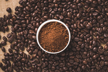 Coffee beans and powder with textured background stock image.