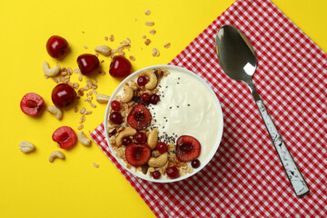Concept of tasty breakfast with yogurt on yellow background