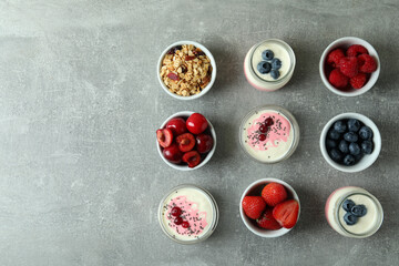 Obraz na płótnie Canvas Concept of tasty breakfast with yogurt on gray textured table