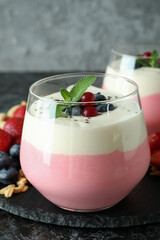 Concept of tasty breakfast with yogurt on black smokey table