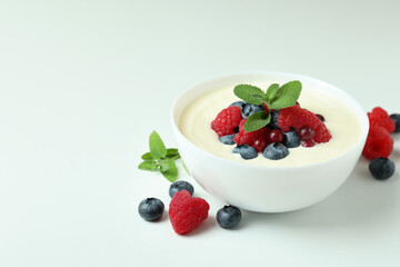 Concept of tasty breakfast with yogurt on white background