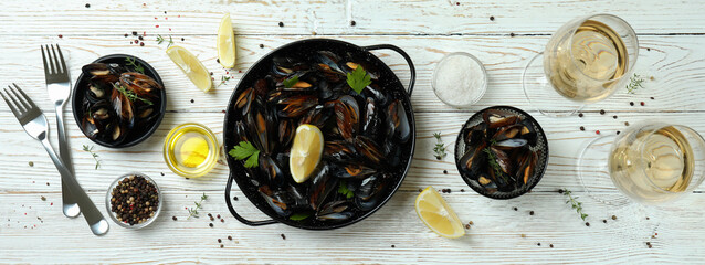 Concept of delicious food with mussels on white wooden table