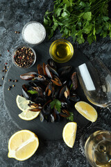 Concept of delicious food with mussels on black smokey table