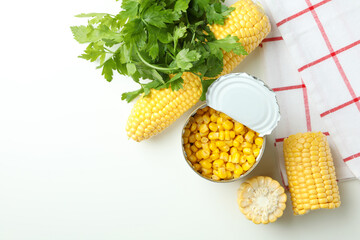 Raw corn and canned corn on white table