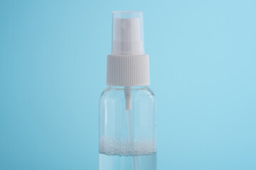 Fototapeta na wymiar A transparent plastic bottle on a blue background