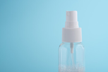 A transparent plastic bottle on a blue background
