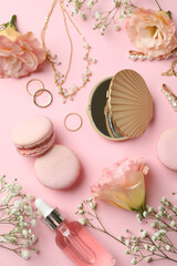 Female accessories and macaroons on pink background