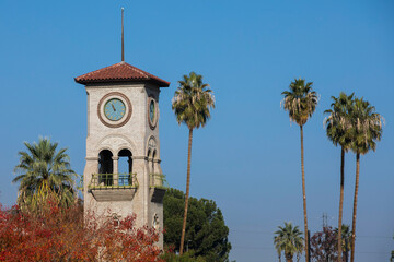 Daytime view of a historic public clock tower in downtown Bakersfield, California, USA. - Powered by Adobe